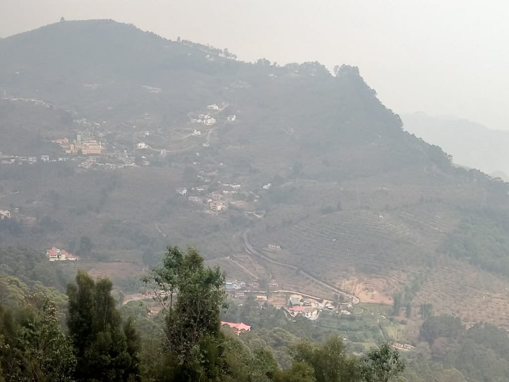 Hillside homes in misty Kodaikanal valley